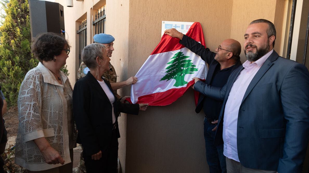 group of people unveiling a sign