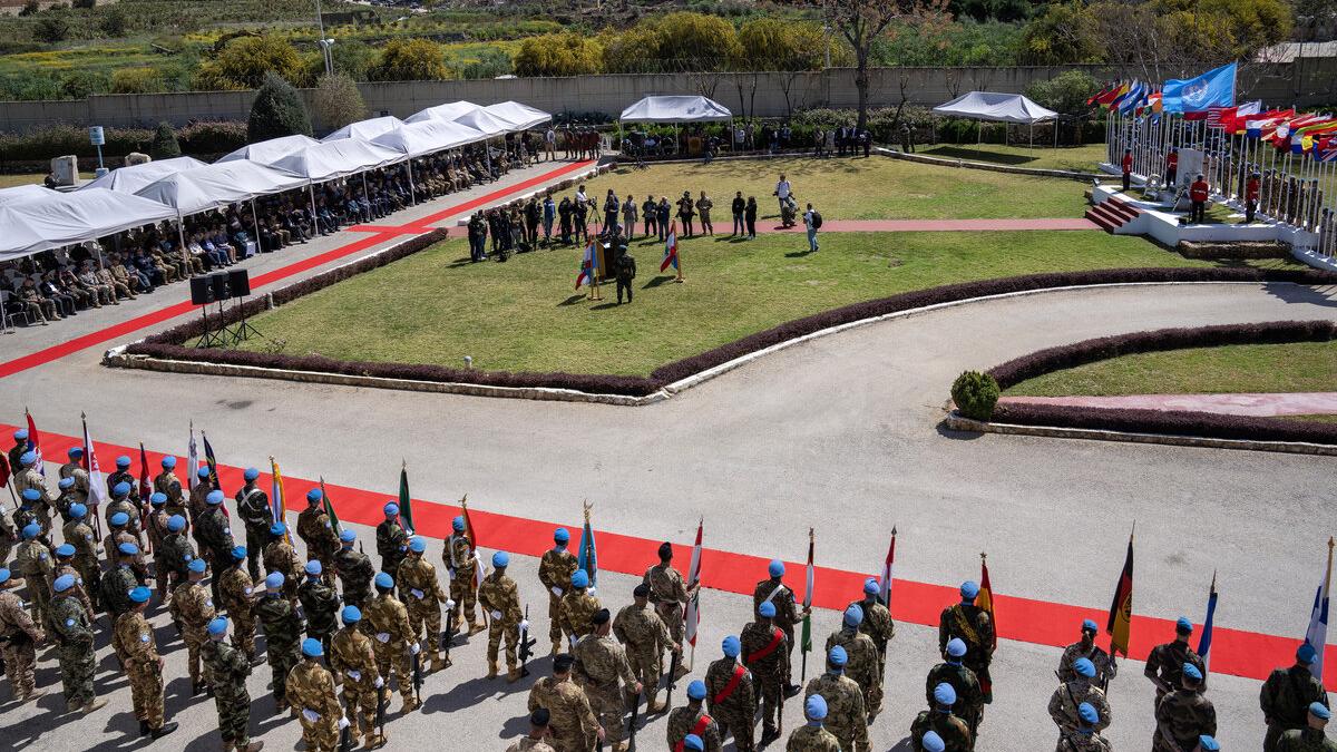 A procession of peacekeepers is photographed from above.