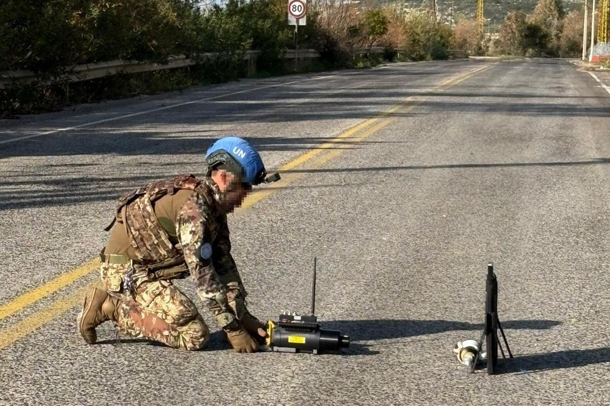 clearing road of crashed armed drone