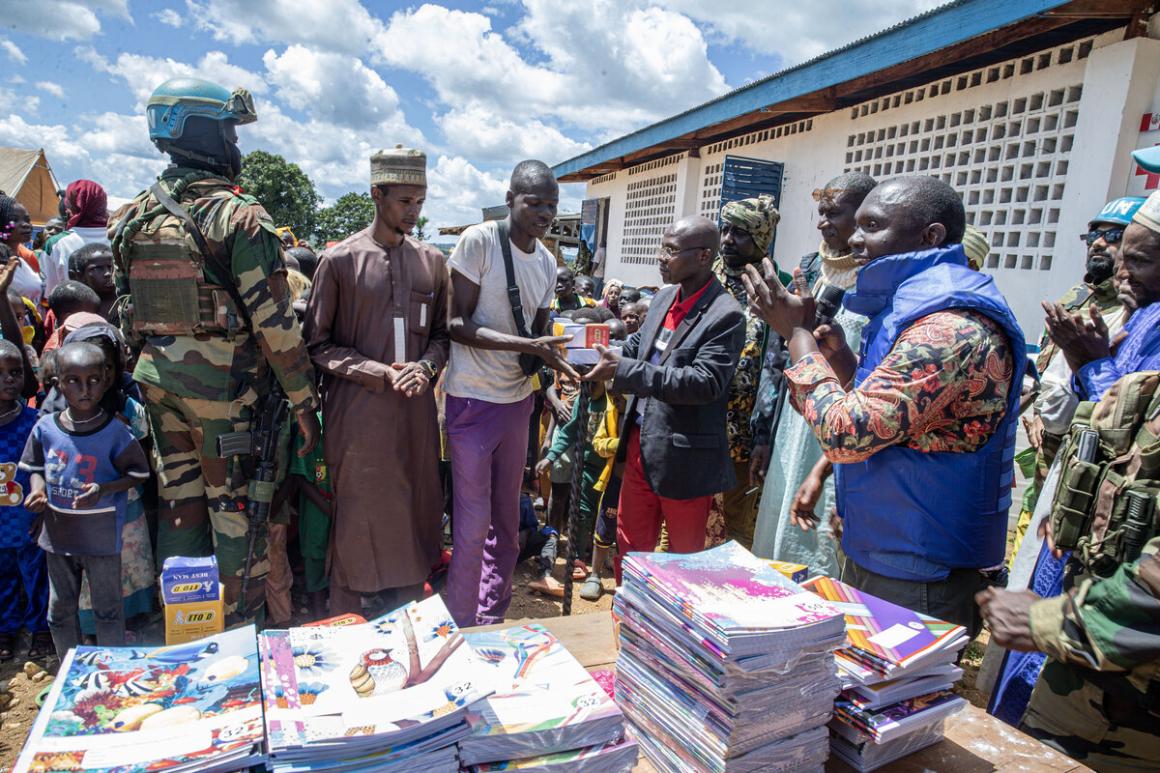 A group stands by a table with writing stationary.