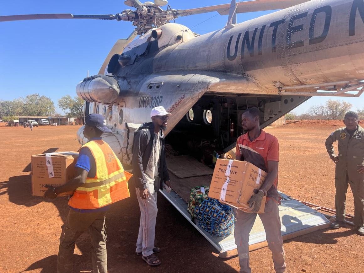 Des personnes déchargent des cartons d'un avion des Nations Unies.
